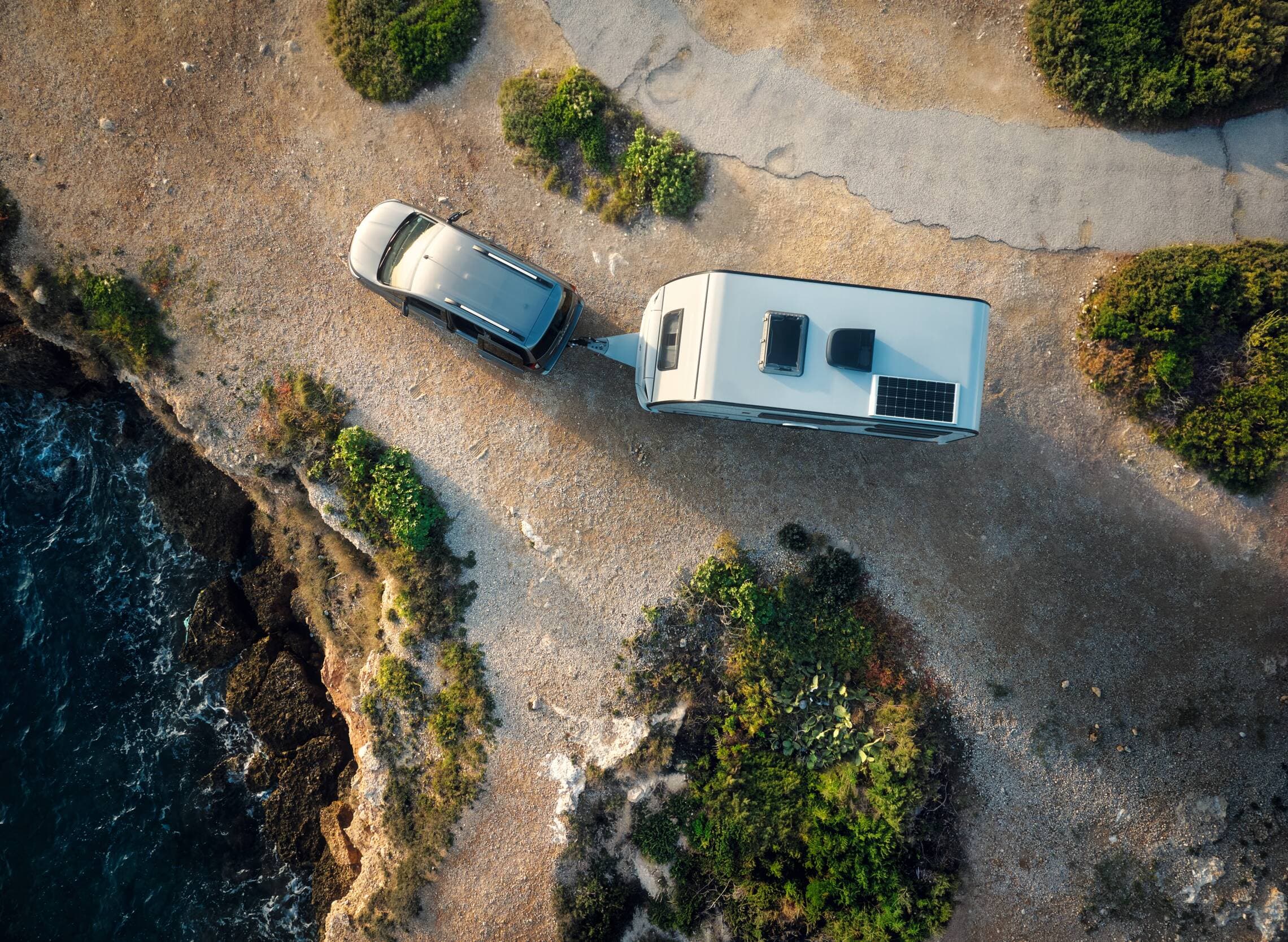 RV and tow vehicle parked near the coast in Tarragona, Spain